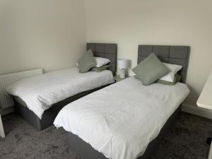 two beds sitting next to each other in a room at 31a locking road in Weston-super-Mare