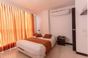 Voodi või voodid majutusasutuse Hotel Plaza Norte Cali toas