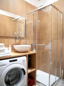 a washing machine in a bathroom with a shower at Il Colle Apartments in Bellagio +67 photos