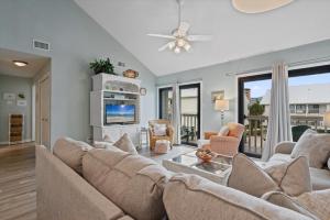a living room with a couch and a tv at Cotton Bayou Unit 4E in Orange Beach