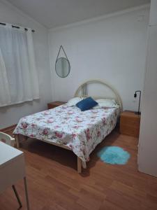 a bedroom with a bed and a blue rug at House Prosperity in Amora