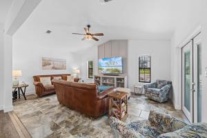 a living room with a couch and a tv at Bayside Bliss in Pensacola
