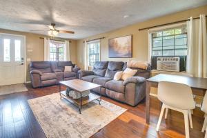 a living room with a couch and a table at Half-Mi to Marina Pet-Friendly Disney Home in Disney