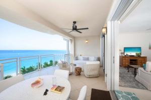 a living room with a view of the ocean at Beachcomber 33 in George Town