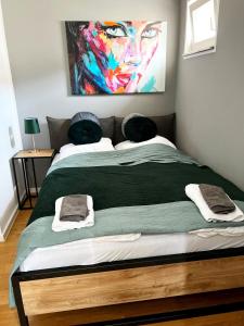 a bedroom with two beds and a painting on the wall at Apartment-City in Cologne