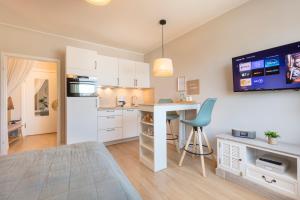 a kitchen with a desk and a table in a room at Grömitz am Strand in Grömitz
