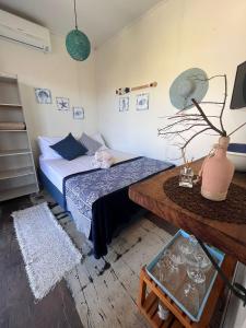 a small room with a bed and a table at Capim Limão Containers do Rosa in Praia do Rosa +37 photos