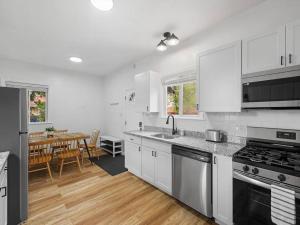 ピッツバーグにあるBloomfield, Shadyside !2 Modern and Spacious Two Bedroom Apt with Free Parkingの白いキャビネット付きのキッチン、ダイニングルーム +14枚の写真