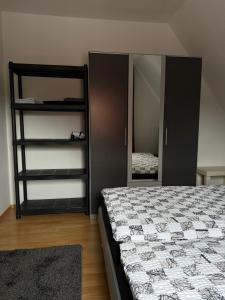 a bedroom with a bed and a closet with a mirror at Hammer Wohnung in Hamm