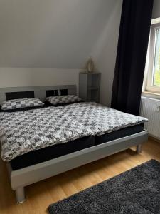 a bedroom with a bed with a comforter at Hammer Wohnung in Hamm
