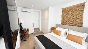 a bedroom with a bed and a desk and a window at Angel Syros Luxury Apartment in Ermoupoli