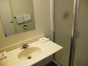 a bathroom with a sink and a mirror and a shower at Motel 6 Ontario, OR in Ontario +19 photos