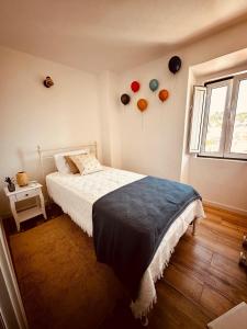 a bedroom with balloons on the wall and a bed at Casa do Castelo in Belver +79 photos