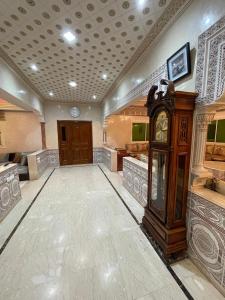 a large room with a grandfather clock in it at Villa Safaa Dar Bouazza in Dar Mouddene +32 photos