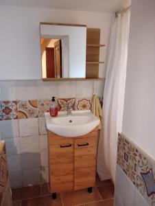 a bathroom with a sink and a mirror at Tabernacolo in Carpineta +7 photos