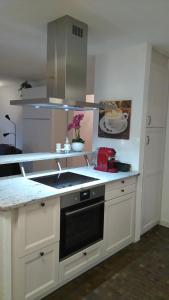 a kitchen with a sink and a stove top oven at Tulai 104E in Scuol