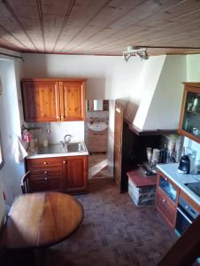 a kitchen with wooden cabinets and a sink and a table at Tabernacolo in Carpineta