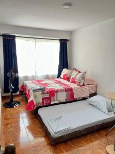 En eller flere senge i et værelse på Central Aparta-estudio Pereira