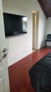 a room with a flat screen tv on a wall at Quinta Ferreyra in Villa Paranacito