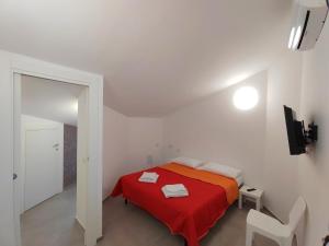 a bedroom with a red bed with a red blanket at Casa Borgo Antico Cavallaro in Gaggi