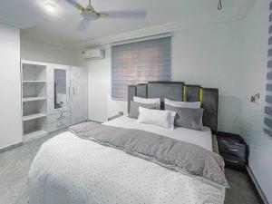 a bedroom with a large bed and a window at Caroline Cozy Apartment in Accra +90 photos