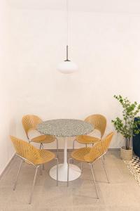 a table and chairs in a room with a white wall at Casa Korsi Apartments At Santa Ana in Panama City