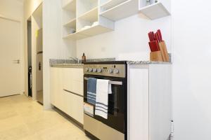 a kitchen with a black and white stove top oven at Casa Korsi Apartments At Santa Ana in Panama City +15 photos