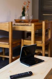 a tablet computer sitting on a table next to a remote control at Résidence Les Melezes - Studio rénové · Accès pistes par navette · Parking extérieur MAE-0684 in Champcella