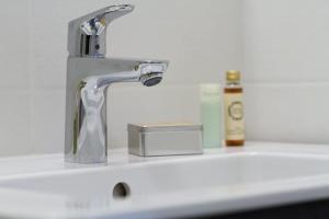 a bathroom sink with a silver faucet on a counter at Résidence Les Melezes - Studio rénové avec parking extérieur · Accès pistes par navette MAE-1054 in Champcella