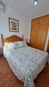 a bedroom with a bed with a wooden headboard at Casa Albahacar in Paymogo +15 photos