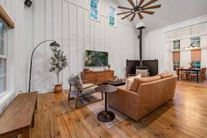 a living room with a couch and a table at NEW White Pine Hideaway Fire pit Hot Tub Games in Ellijay