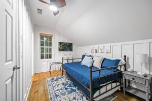 a bedroom with a bed with blue sheets and a window at NEW White Pine Hideaway Fire pit Hot Tub Games in Ellijay +53 photos