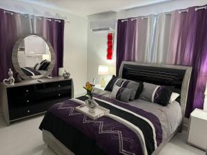 a bedroom with a bed with purple curtains and a mirror at Casa Mi Luz - Family-Friendly 3BR Stay with Parking & Self Check-in in San Juan