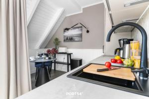 a kitchen with a sink and a counter with a cutting board at Ferienwohnung Erholen St Peter Ording in Böhl