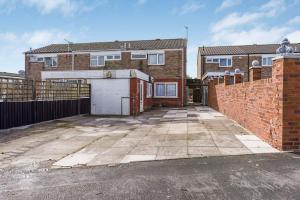 a brick house with a gate and a driveway at Villa Casa in Birmingham
