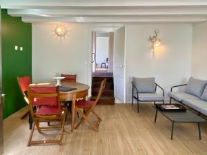 a living room with a table and chairs and a couch at Clos des Mésanges in Chisseaux +51 photos