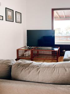a living room with a couch and a flat screen tv at Casa Buna Colorada in Playa Blanca