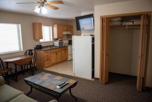 a kitchen with a white refrigerator and a table at The Sawmill Inn in Houston