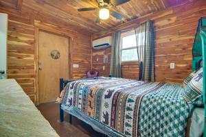 a bedroom with a bed in a log cabin at Fish, Hike and More Ozark Cabin on 300 Acres in Ozark