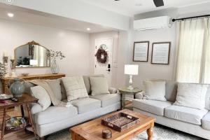 a living room with two couches and a table at Norris Lake Modern Farmhouse Retreat in Sharps Chapel