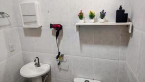 a white bathroom with a sink and a shower at Residencial Carvalho AP 1 in Torto +22 photos