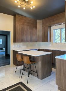 a kitchen with wooden cabinets and a island with stools at Pond Hill Place in Wallingford