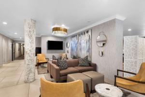 a living room with a couch and a tv at Best Western Plus Abbey Inn in St. George