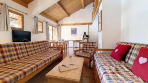 a living room with two couches and a table at Résidence Hors Piste - Appartement spacieux en duplex · Au pied des pistes · Balcon MAE-9664 in Saint-Martin-de-Belleville