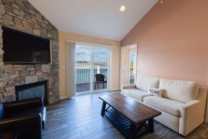a living room with a couch and a fireplace at Norseman Resort on the Beach in Ogunquit