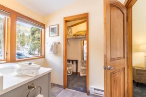 a bathroom with a sink and a mirror at Tennis Townhome 1337 : 2 in Keystone +32 photos