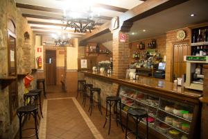 a bar in a restaurant with bar stools at Hostal Hueso in Trujillo