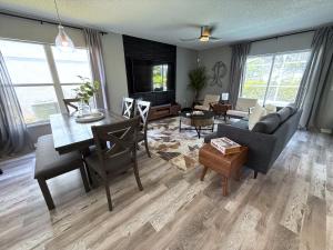 a living room with a table and a dining room at Updated Southern Dunes Pool Home in Haines City
