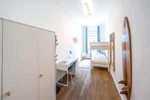 a white bathroom with a sink and a mirror at Your serenity bubble - Brussels center in Brussels