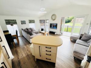 a living room with a couch and a table at 3 Bedroom Lodge SG2, Lower Hyde, Isle of Wight in Shanklin